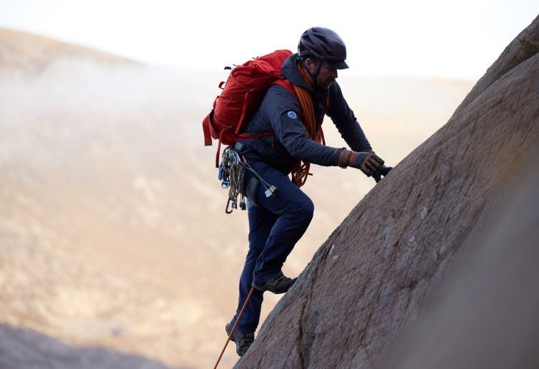 A mountaineer scrambling up Idwal Buttress